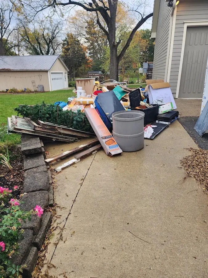 Dumpster being loaded with debris for Estate Cleanout Dumpster Rental in Bridgeport